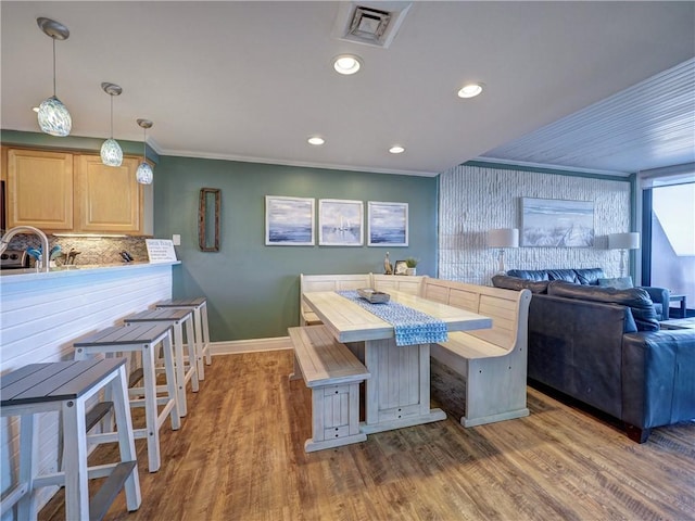 dining area with crown molding and dark hardwood / wood-style floors