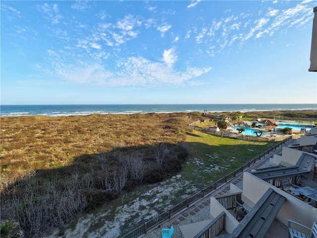 birds eye view of property featuring a beach view and a water view