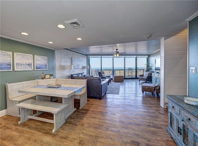 dining space featuring floor to ceiling windows, ceiling fan, hardwood / wood-style floors, and ornamental molding