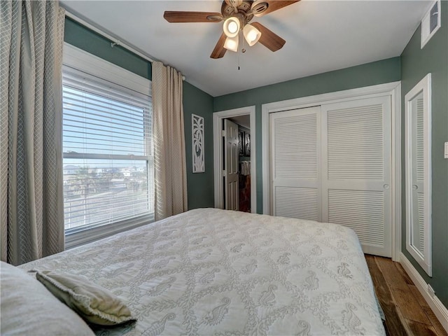 bedroom with ceiling fan and dark hardwood / wood-style floors