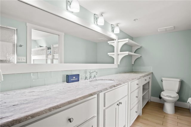 bathroom featuring hardwood / wood-style floors, toilet, and vanity