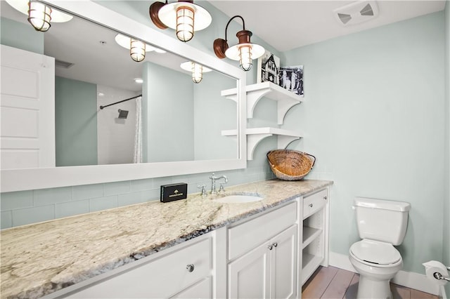 bathroom featuring toilet, tasteful backsplash, wood-type flooring, a shower with shower curtain, and vanity