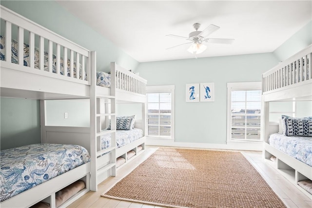 bedroom with ceiling fan and multiple windows