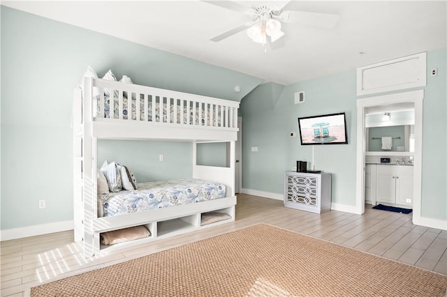 bedroom featuring sink, ceiling fan, connected bathroom, and hardwood / wood-style floors