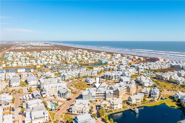 aerial view with a water view and a view of the beach