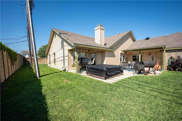 5422 Pressler Dr, Corpus Christi, TX 78413 - back of property featuring a patio, a chimney, a fenced backyard, and a lawn