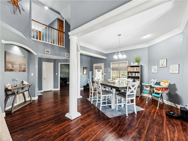 5422 Pressler Dr, Corpus Christi, TX 78413 - dining space featuring baseboards, an inviting chandelier, ornamental molding, ornate columns, and wood finished floors