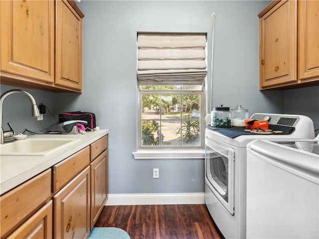 5422 Pressler Dr, Corpus Christi, TX 78413 - clothes washing area featuring dark wood finished floors, cabinet space, a sink, baseboards, and washing machine and dryer