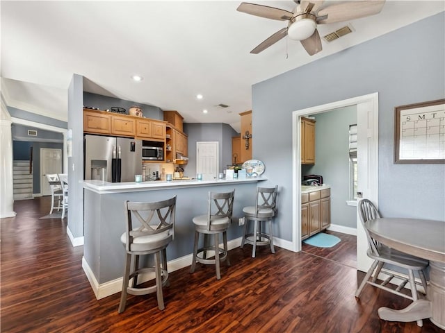 5422 Pressler Dr, Corpus Christi, TX 78413 - kitchen featuring a kitchen bar, a ceiling fan, visible vents, stainless steel appliances, and dark wood-style floors