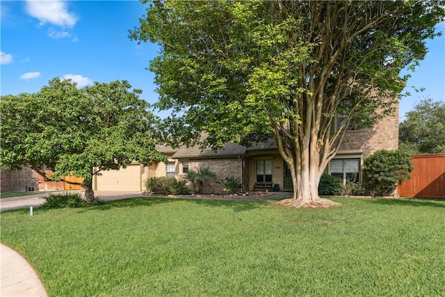 5422 Pressler Dr, Corpus Christi, TX 78413 - single story home featuring brick siding, a front lawn, fence, and an attached garage
