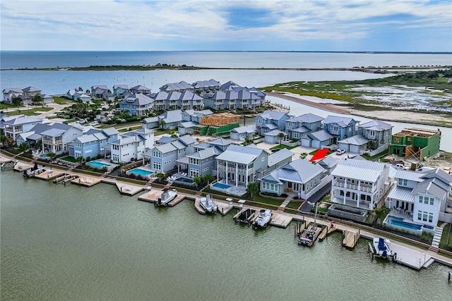 drone / aerial view featuring a water view and a residential view