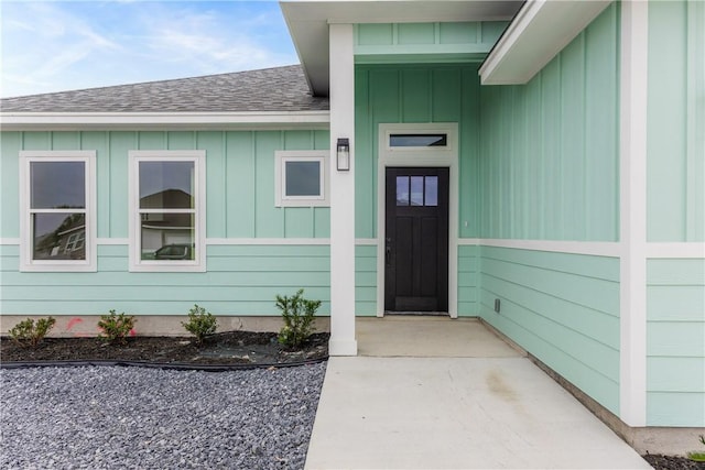 15638 Escapade St, Corpus Christi, TX 78418 - view of exterior entry with board and batten siding and roof with shingles