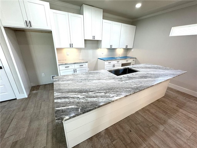 15638 Escapade St, Corpus Christi, TX 78418 - kitchen featuring white cabinetry, stone countertops, wood finished floors, ornamental molding, and recessed lighting