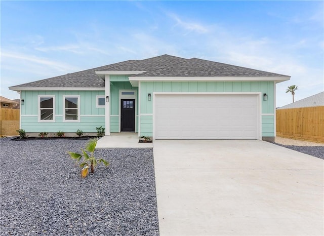 15638 Escapade St, Corpus Christi, TX 78418 - ranch-style house featuring board and batten siding, a shingled roof, concrete driveway, and a garage