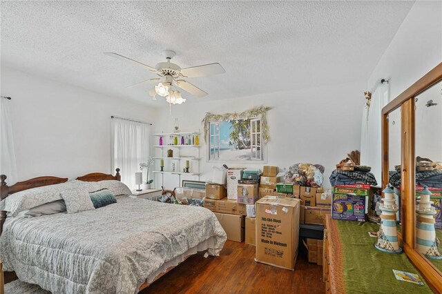 bedroom featuring a textured ceiling, a ceiling fan, and wood finished floors