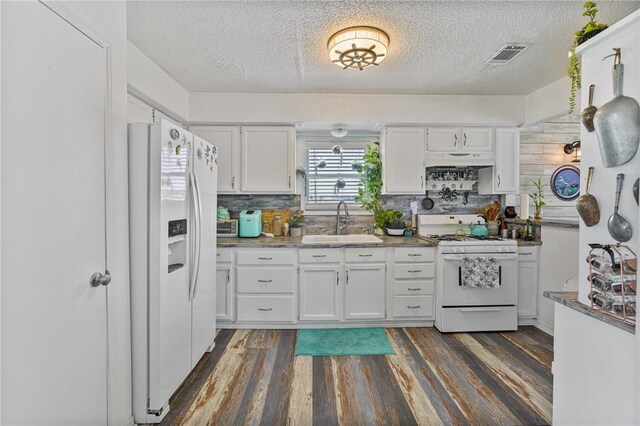 kitchen with a sink, white appliances, under cabinet range hood, and white cabinets