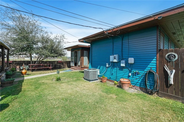 view of yard with entry steps, cooling unit, and fence