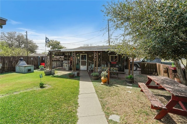 view of front of home with a fenced backyard and a front lawn