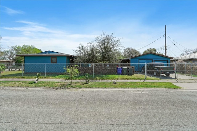 view of front of property with an outdoor structure, fence private yard, and a gate