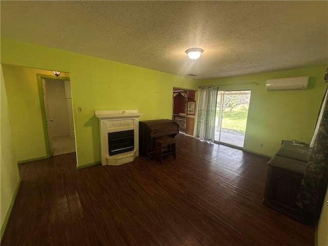 225 W Gile Ave, Aransas Pass, TX 78336 - living room featuring dark wood-type flooring, a textured ceiling, and a wall mounted AC