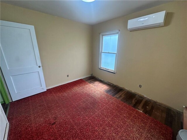 225 W Gile Ave, Aransas Pass, TX 78336 - spare room featuring dark wood-style flooring and a wall mounted AC