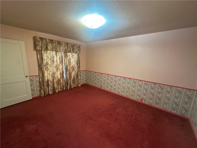 225 W Gile Ave, Aransas Pass, TX 78336 - spare room with carpet and wallpapered walls