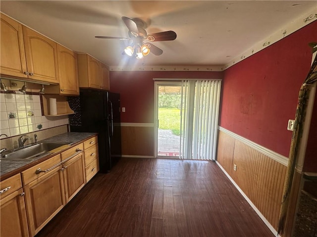 225 W Gile Ave, Aransas Pass, TX 78336 - kitchen featuring dark countertops, ceiling fan, a sink, a wainscoted wall, and dark wood-style floors