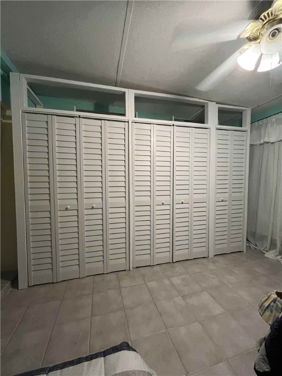 interior space with ceiling fan