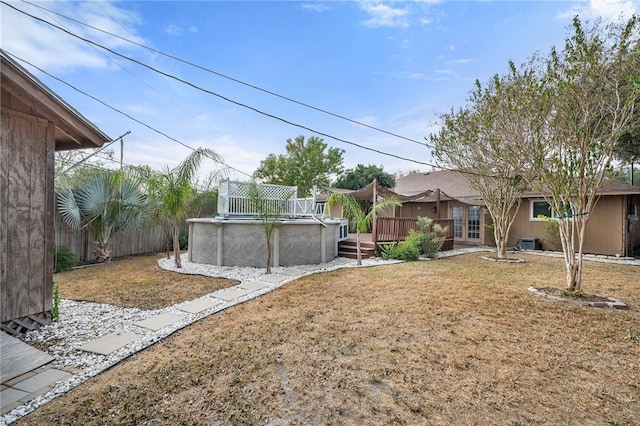 view of yard with cooling unit and a pool side deck