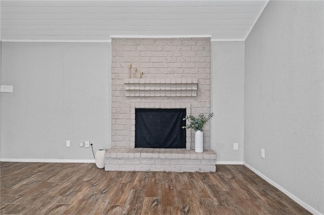 interior details with hardwood / wood-style flooring, ornamental molding, and a fireplace