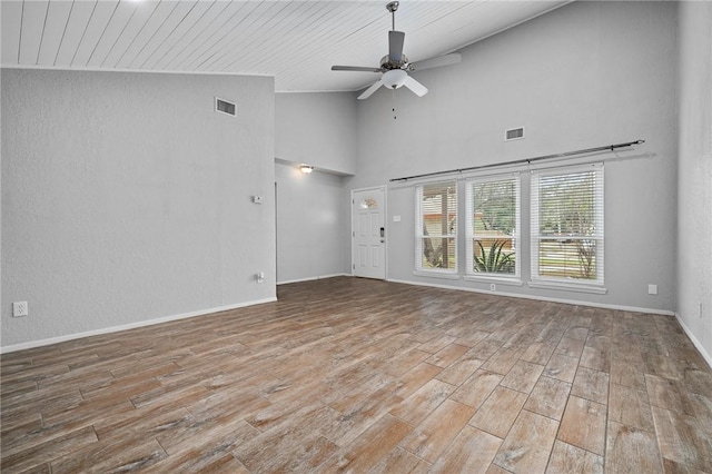 unfurnished living room with high vaulted ceiling and ceiling fan