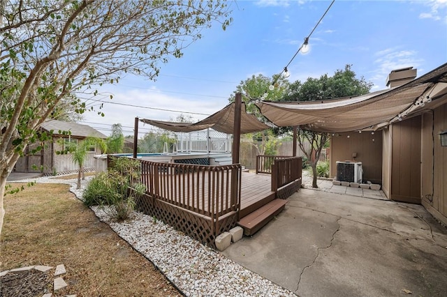 exterior space featuring a patio, a fenced in pool, and central AC unit