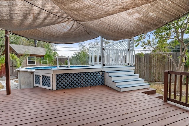 wooden terrace with a fenced in pool