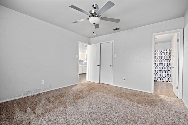 unfurnished bedroom with carpet floors and ceiling fan