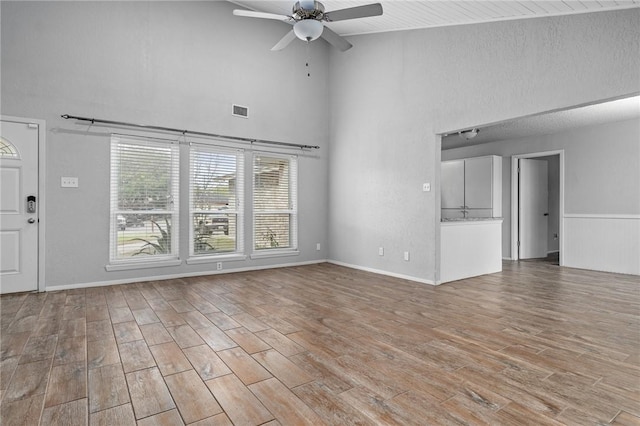 unfurnished living room with ceiling fan