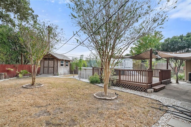 view of yard with a patio area, a storage shed, and a wooden deck