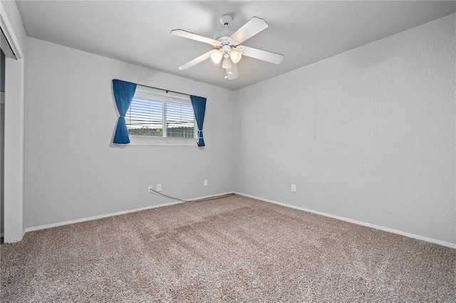 spare room featuring carpet and ceiling fan