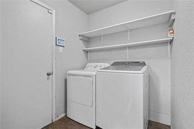 washroom with independent washer and dryer and dark hardwood / wood-style flooring