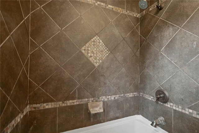interior details with a tub and tiled shower