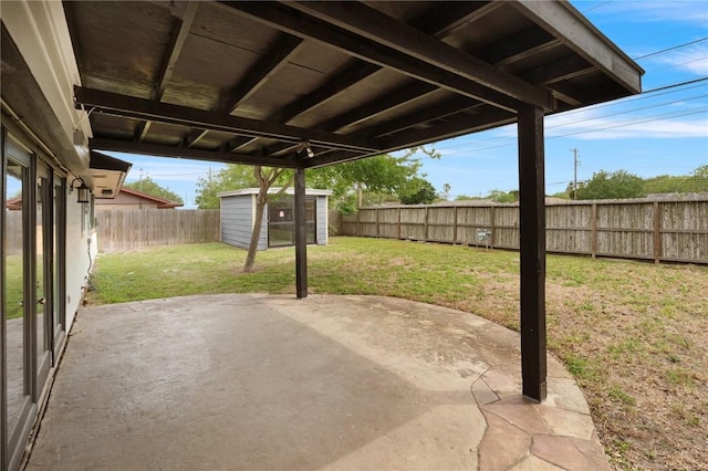view of patio with a storage shed, an outbuilding, and a fenced backyard