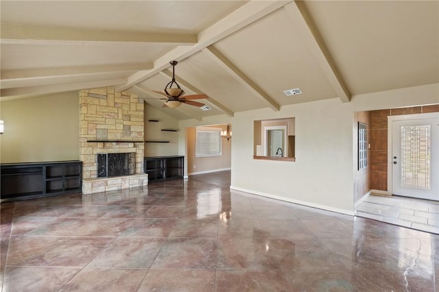 unfurnished living room with a ceiling fan, a stone fireplace, beamed ceiling, baseboards, and visible vents
