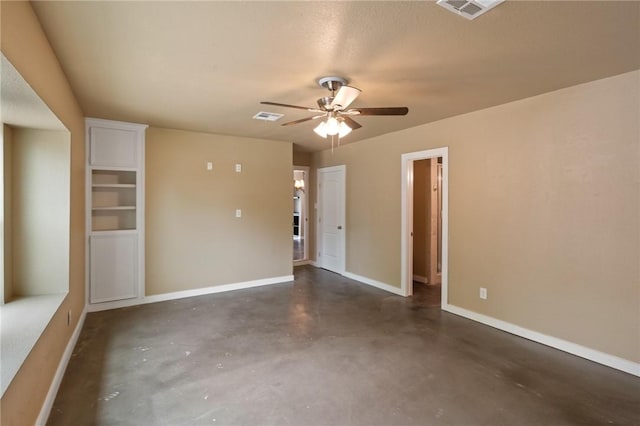 unfurnished room with visible vents, finished concrete flooring, baseboards, and a ceiling fan