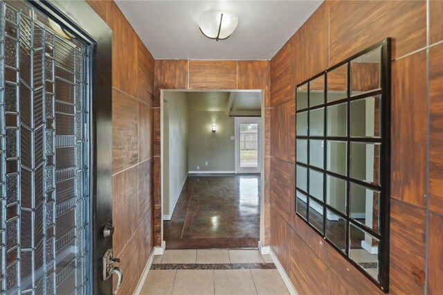 interior space with tile patterned floors and baseboards
