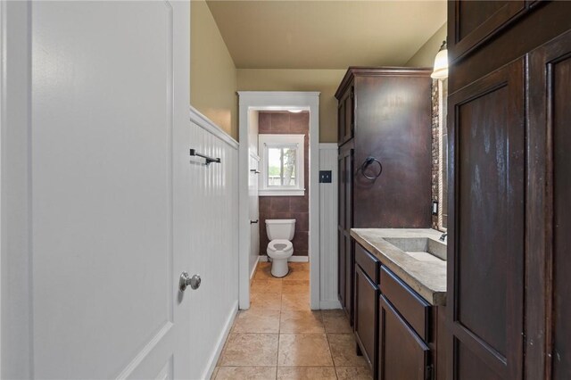 bathroom with vanity, tile patterned flooring, and toilet