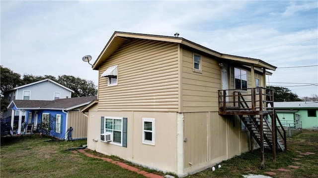 view of side of property with cooling unit and a yard