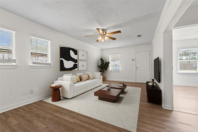 2853 Lawnview St, Corpus Christi, TX 78404 - living area featuring a textured ceiling, wood finished floors, and a ceiling fan