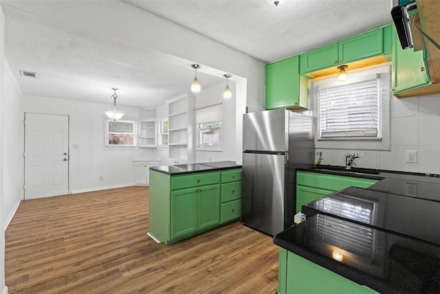 2853 Lawnview St, Corpus Christi, TX 78404 - kitchen featuring green cabinetry, freestanding refrigerator, dark countertops, wood finished floors, and a textured ceiling