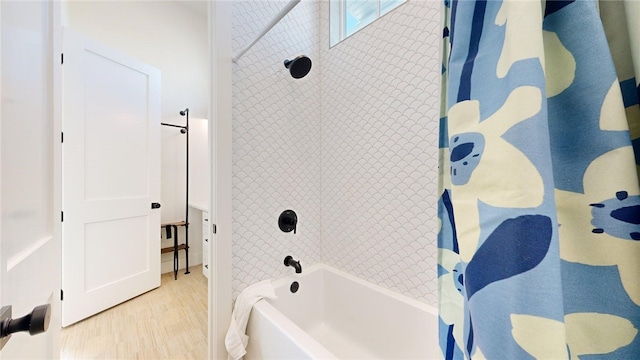 full bathroom featuring shower / bath combination and wood finished floors