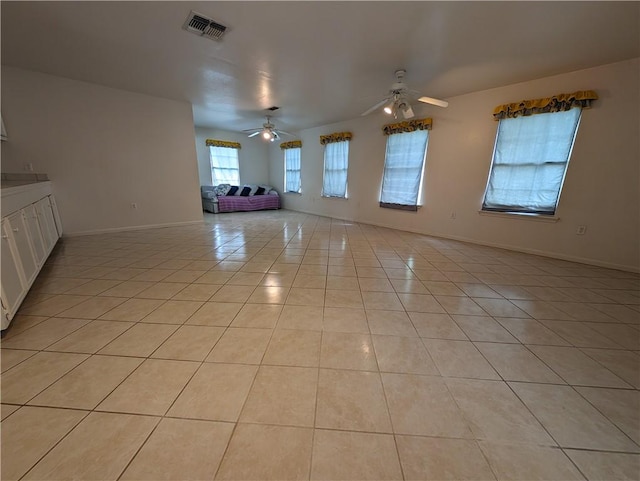 empty room featuring ceiling fan and light tile patterned floors