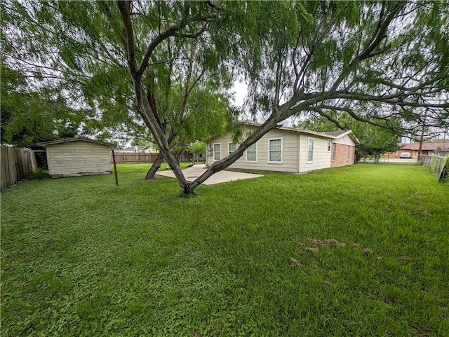 view of yard featuring a patio area and a shed